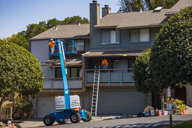 Professional pressure washer cleaning grime from a residential concrete driveway
