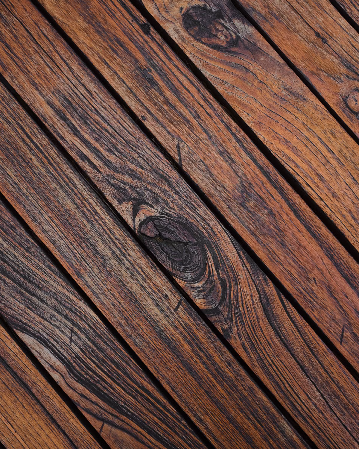 Clean wooden deck beside a Charlotte backyard after professional pressure washing